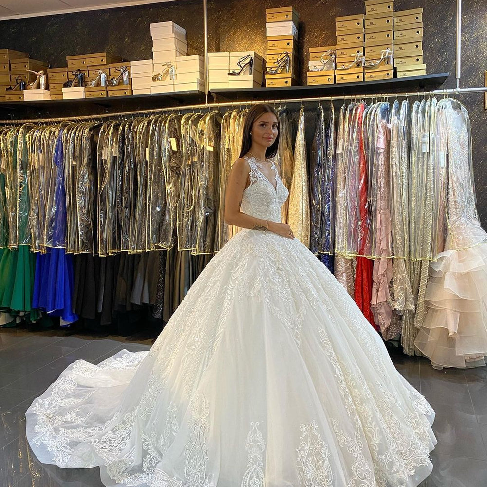 
                      
                        Gorgeous Lace Backless Floor-Length Wedding Dress with Train and V-Neck Appliques
                      
                    