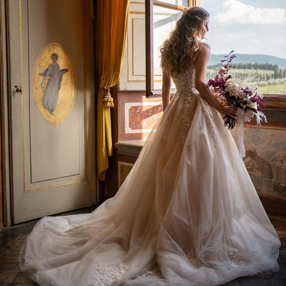 
                      
                        Sweetheart Backless Train A-Line Wedding Dress with Tulle and Floral Lace
                      
                    