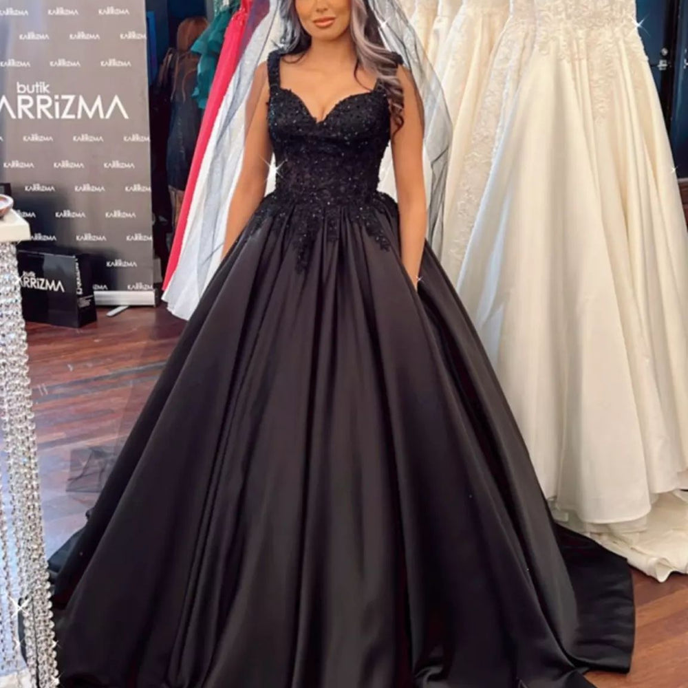 
                      
                        Black Sweetheart Wide Strap Ball Gown Floor-Length Wedding Dress with Ruffles and Satin
                      
                    