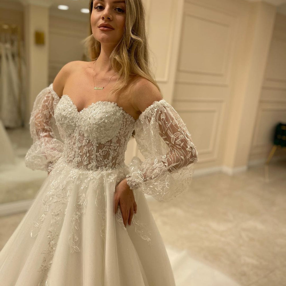 
                      
                        Sweetheart Long Sleeve Backless A-Line Train Wedding Dress with Lace Appliques
                      
                    