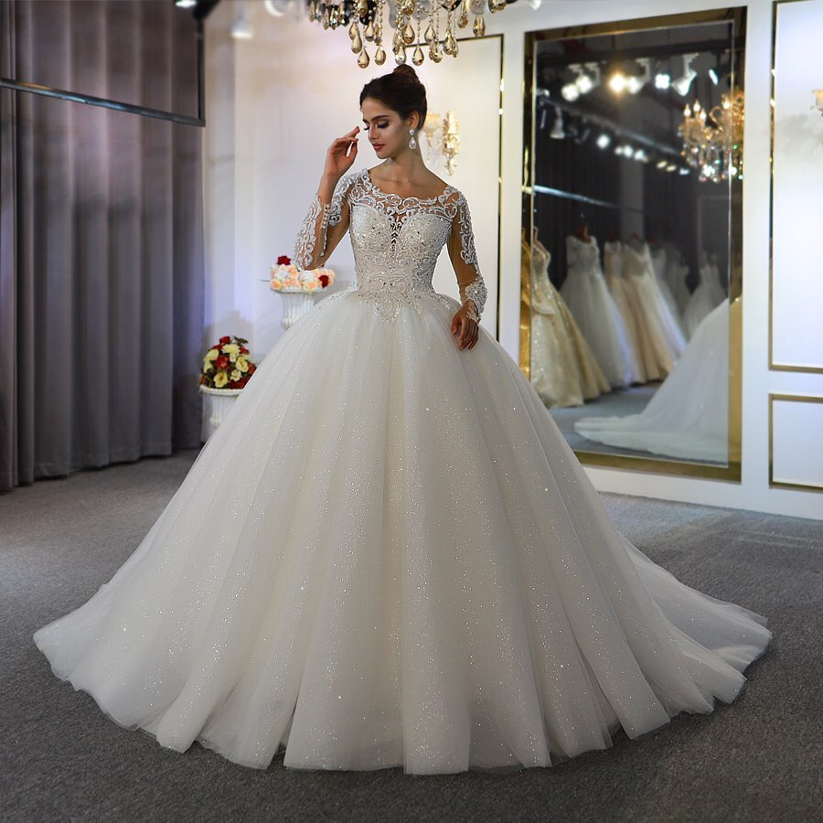 
                      
                        Gorgeous A-Line Bateau Long Sleeve Floor-Length Wedding Dress with Lace and Sequin Appliques
                      
                    