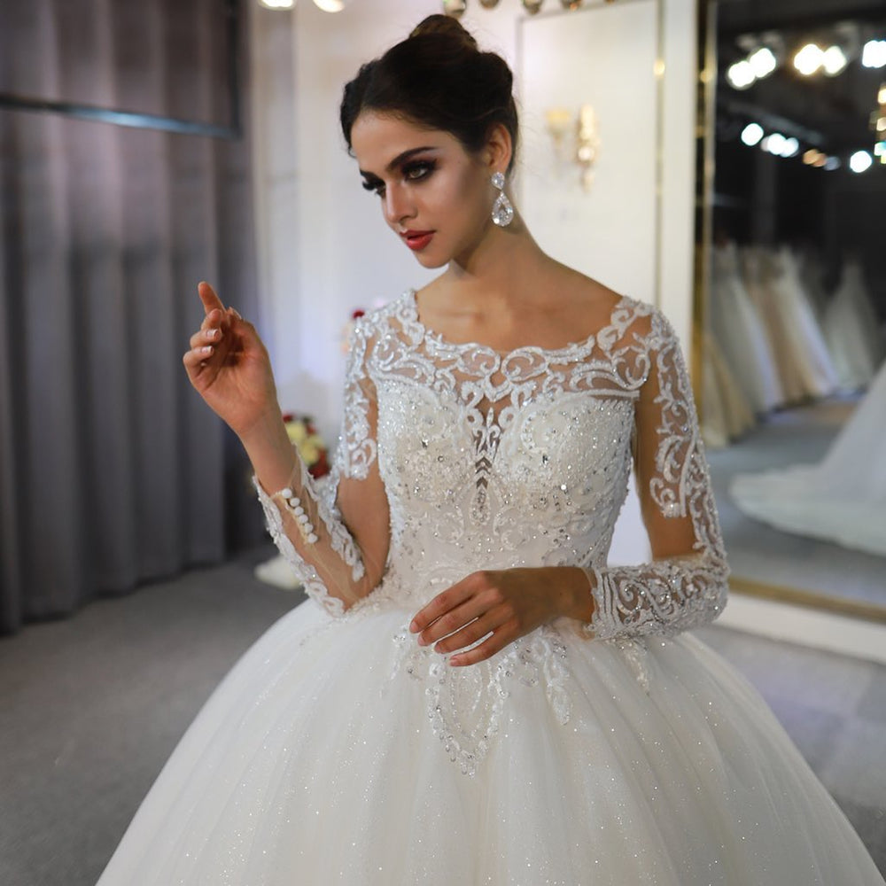 
                      
                        Gorgeous A-Line Bateau Long Sleeve Floor-Length Wedding Dress with Lace and Sequin Appliques
                      
                    