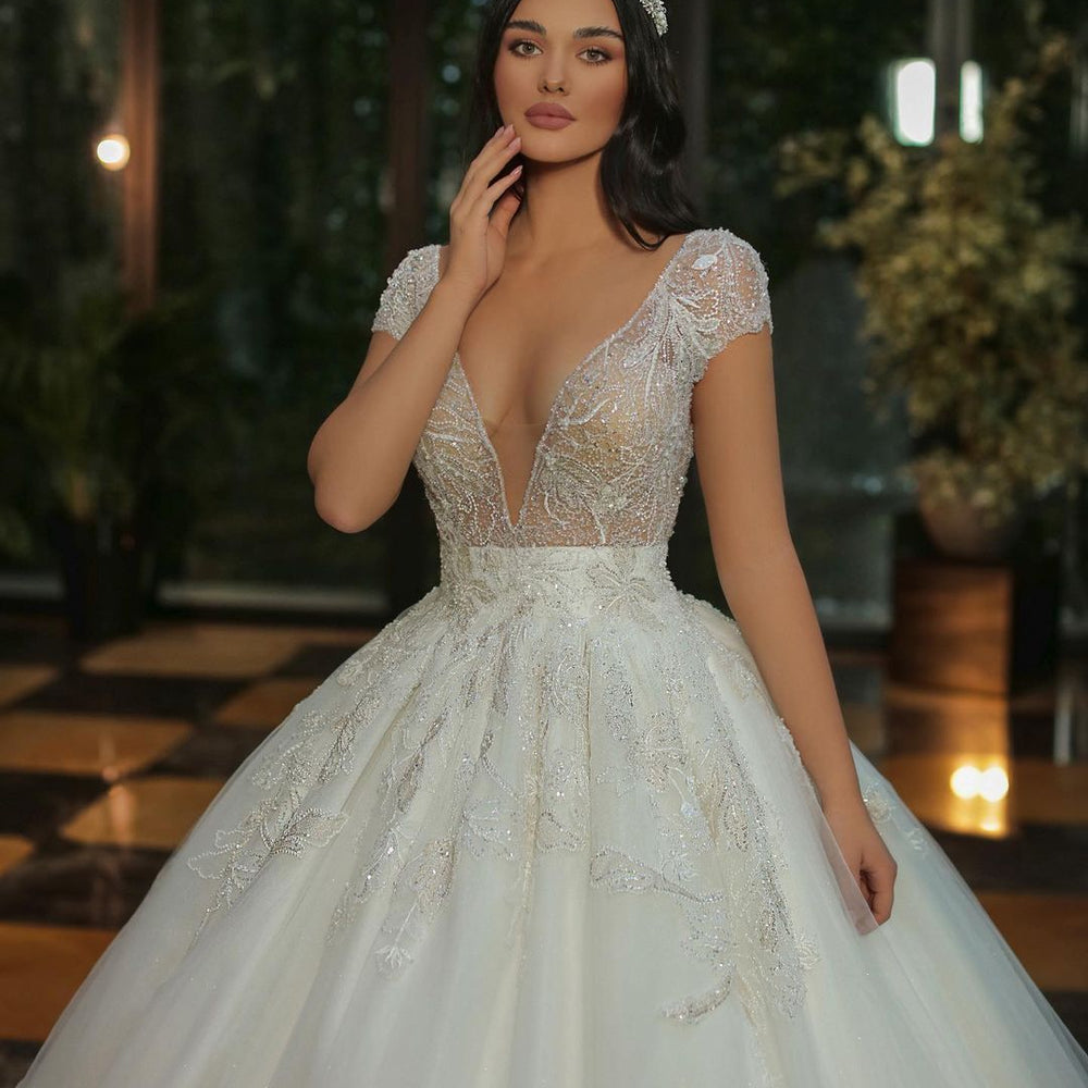 
                      
                        Long A-Line V-Neck Cap Sleeve Wedding Dress with Beaded Tulle
                      
                    