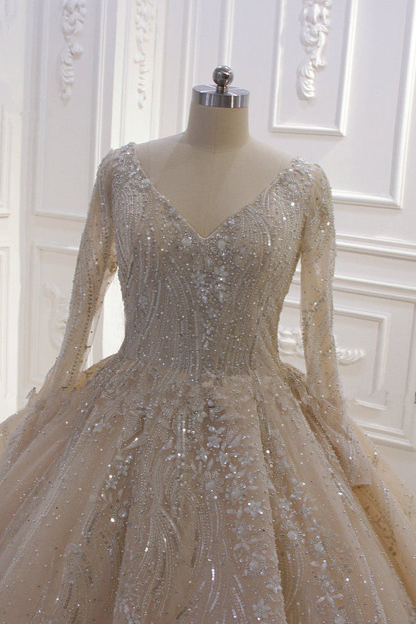 
                      
                        Long Sleeve V-Neck Ball Gown Wedding Dress with Sequins, Beading, and Ruffles
                      
                    