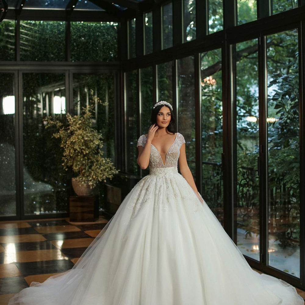 
                      
                        Long A-Line V-Neck Cap Sleeve Wedding Dress with Beaded Tulle
                      
                    