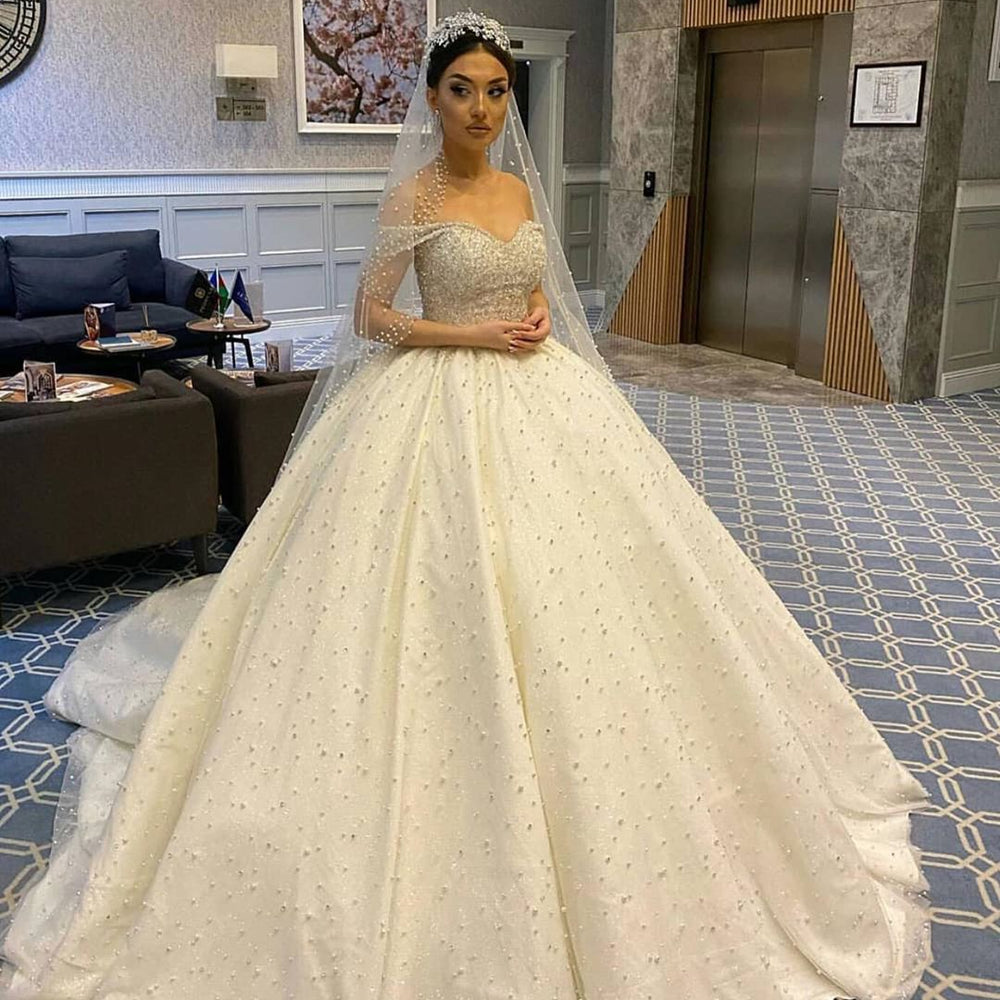 
                      
                        Sweetheart Off-the-Shoulder Backless Ball Gown Wedding Dress with Pearl Beading and Ruffles
                      
                    